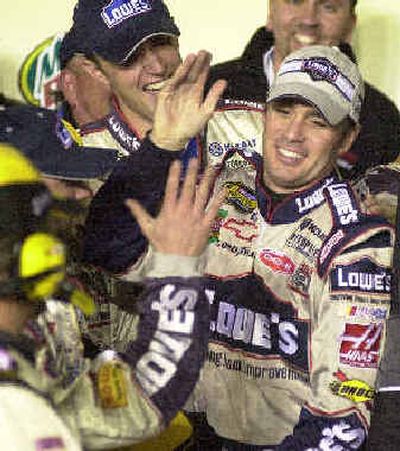 
Jimmie Johnson, center, gives a high five to his crew as they celebrate victory at Darlington. 
 (Associated Press / The Spokesman-Review)