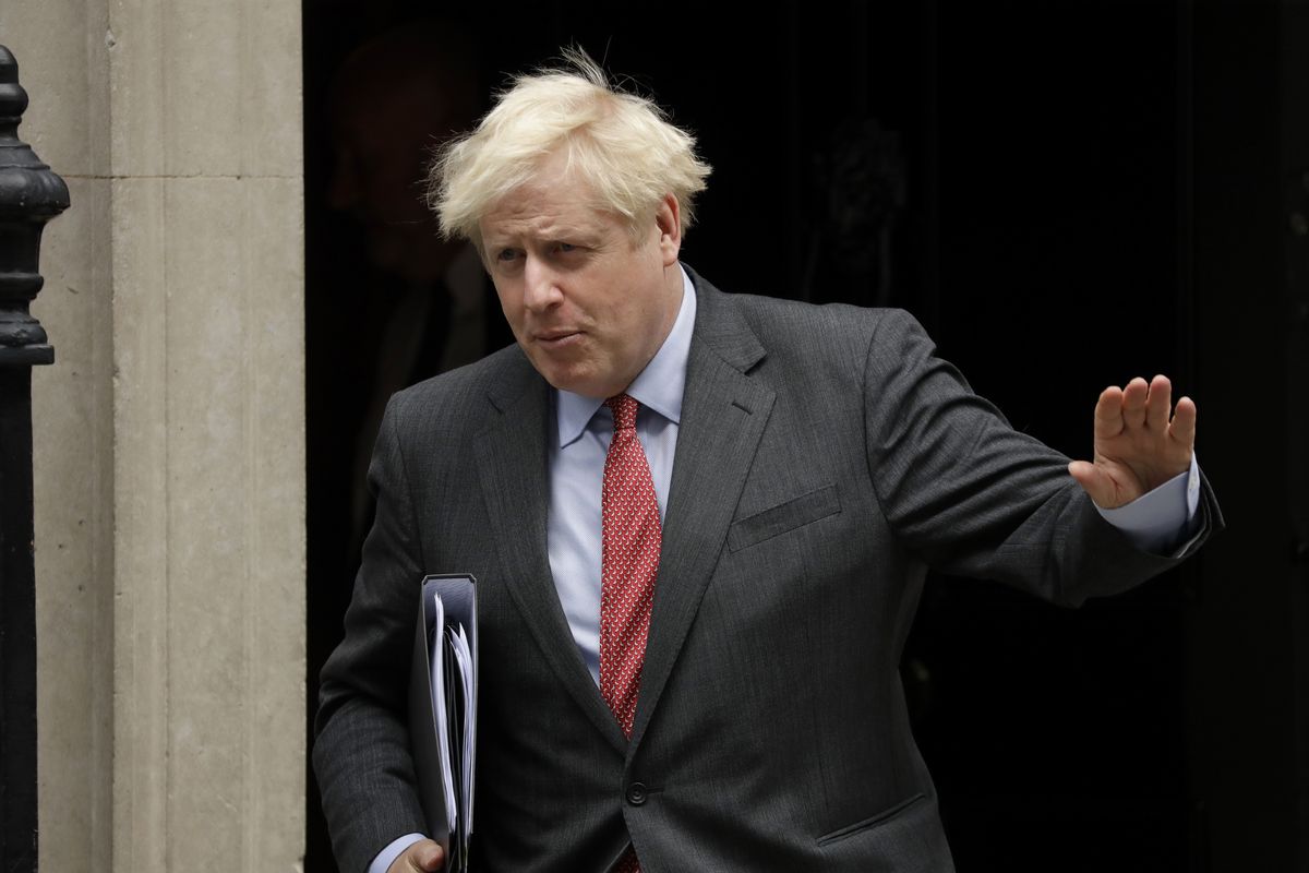 British Prime Minister Boris Johnson waves at the media as he leaves 10 Downing Street, in London, to go to the Houses of Parliament to make a statement on new coronavirus restrictions Tuesday, Sept. 22, 2020. Johnson plans to announce new restrictions on social interactions Tuesday as the government tries to slow the spread of COVID-19 before it spirals out of control.  (Matt Dunham)