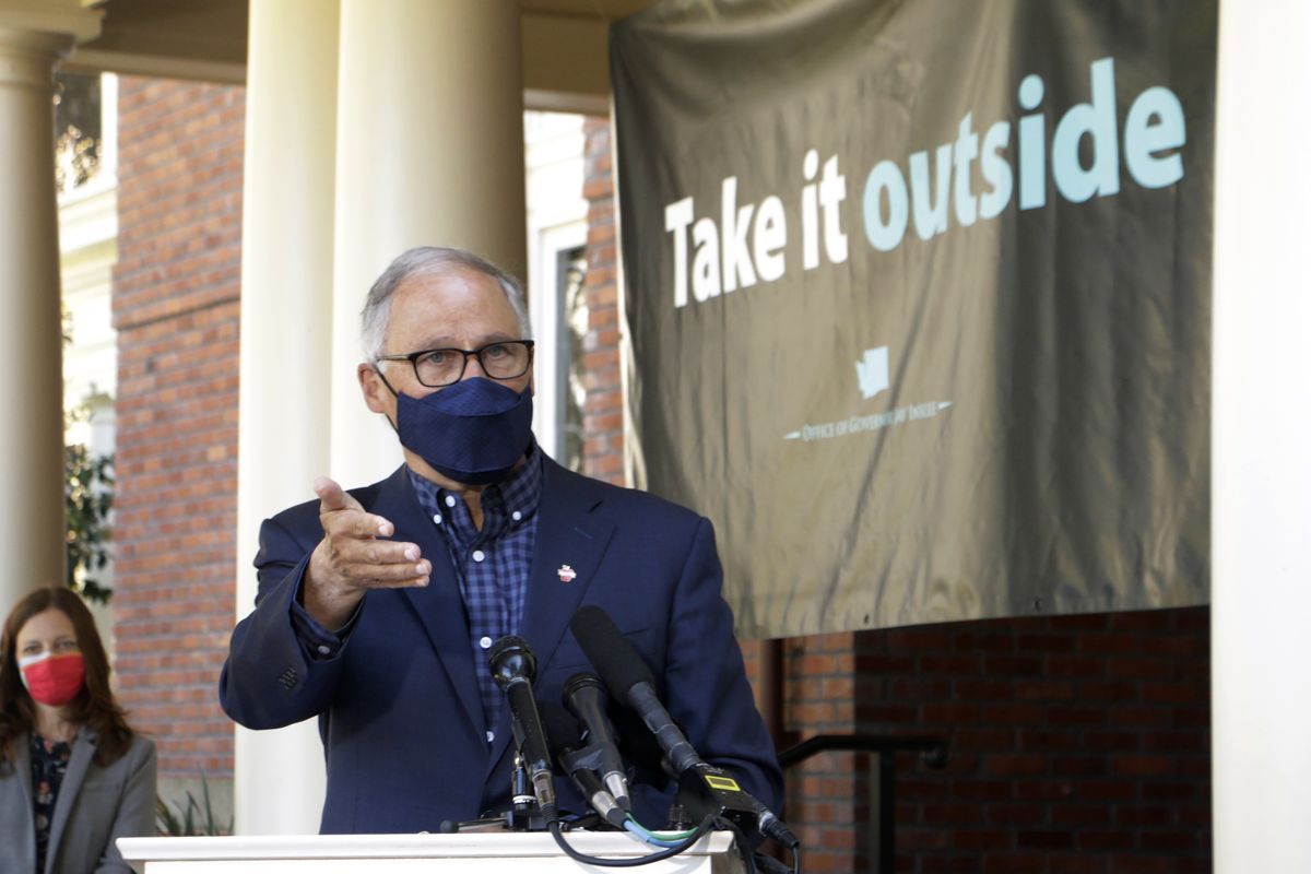 Washington Gov. Jay Inslee speaks at an outdoor press conference. Inslee announced Thursday that the state is on track to fully reopen by June 30.  (Rachel La Corte/AP Photo)