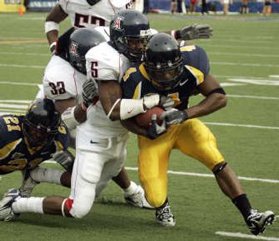 
Cal's Jahvid Best, right, is tackled by Arizona cornerback Antoine Cason. The Bears won 45-27. Associated Press
 (Associated Press / The Spokesman-Review)
