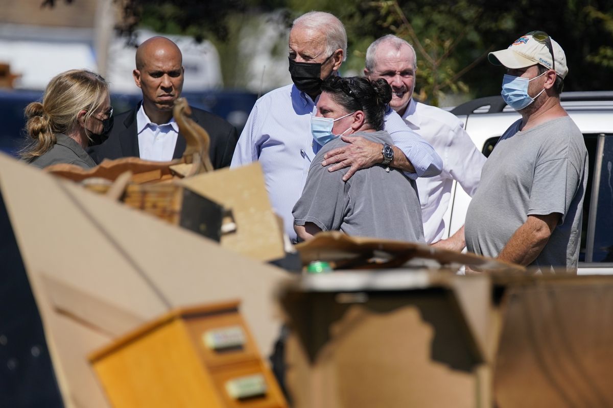 President Joe Biden hugs a person as he tours a neighborhood impacted by Hurricane Ida on Tuesday in Manville, N.J.  (Evan Vucci)