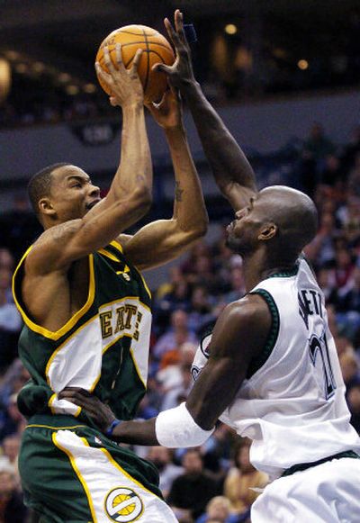 
Minnesota's Kevin Garnett fouls Seattle's Rashard Lewis during the fourth quarter. 
 (Associated Press / The Spokesman-Review)