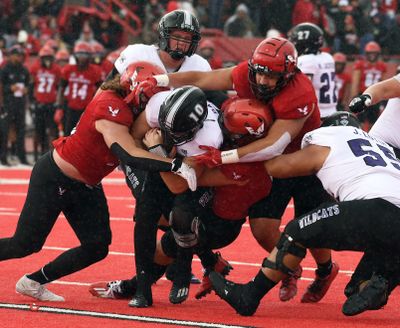 Weber State quarterback Bronson Barron is swarmed by the Eastern Washington defense during their Oct. 23, 2021 game at Roos Field in Cheney.   (Colin Mulvany/THE SPOKESMAN-REVIEW)