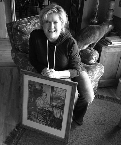 Spokane artist Gina Freuen with an early painting by her mother. (cheryl-Anne Millsap / Photo by Cheryl-Anne Millsap)