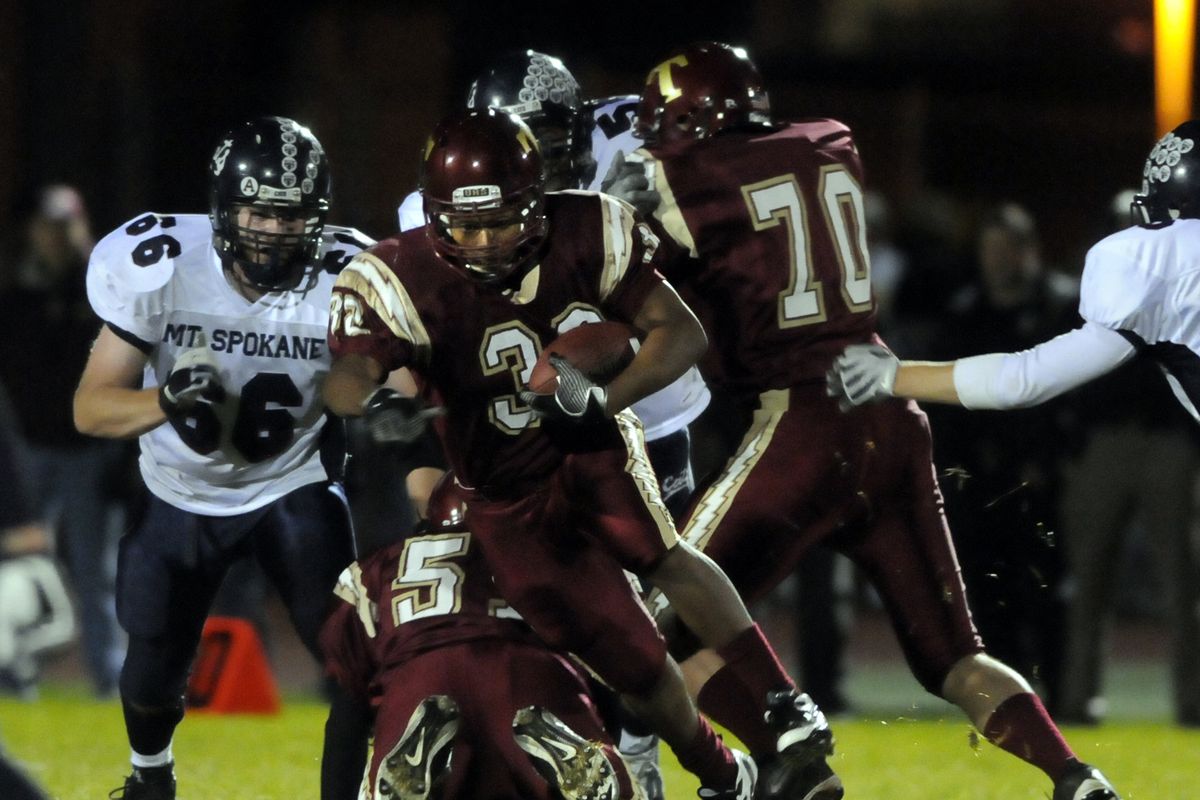 University’s John Wright breaks through the Mt. Spokane defense, including Taylor Smith (66), in the first quarter Friday night at U-Hi. (Jesse Tinsley / The Spokesman-Review)