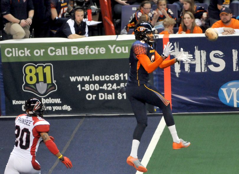 Spokane Shock's Markee White, right, turns inside cover man, Joe Phinisee, of the Cleveland Gladiators and makes a reception before turning into the end zone for a touchdown on Saturday, March 19, 2011, at the Spokane Arena. (Jesse Tinsley / The Spokesman-Review)