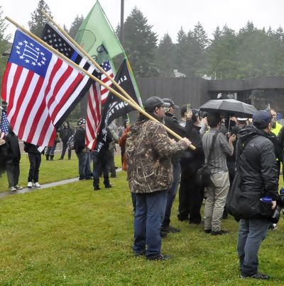 OLYMPIA -- Members of the Patriot Prayer protest group carried a wide variety of flags at their demonstration Thursday on The Evergreen State College campus.  (Jim Camden/The Spokesman-Review)