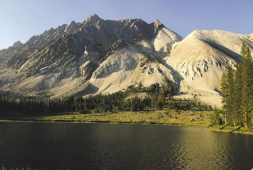 Castle Peak towers over a lake in the newly created White Clouds Wilderness area. The 11,814-foot peak is a popular day trip for backpackers staying in Chamberlain Basin.  (Luke Ramseth / Post-Register via AP)