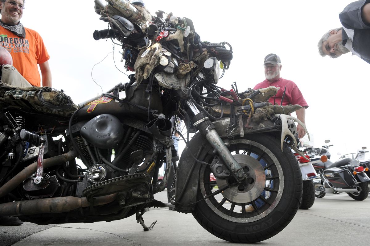 Milo Anderson, left, of Roseburg, Ore., shows off his motorcycle Wednesday at Shumate Harley-Davidson in Spokane Valley.  (Photos by Dan Pelle / The Spokesman-Review)