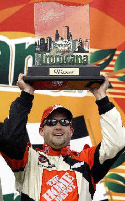 
Tony Stewart holds the Tropicana 400 trophy after winning Sunday's race. 
 (Associated Press / The Spokesman-Review)