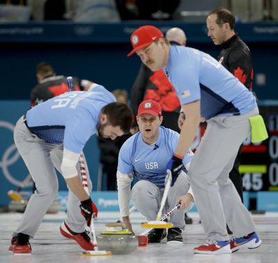 The United States’ John Shuster, center, watches teammates John Landsteiner, left, and Matt Hamilton sweep the ice during the Olympic curling competition last month. (Natacha Pisarenko / AP)