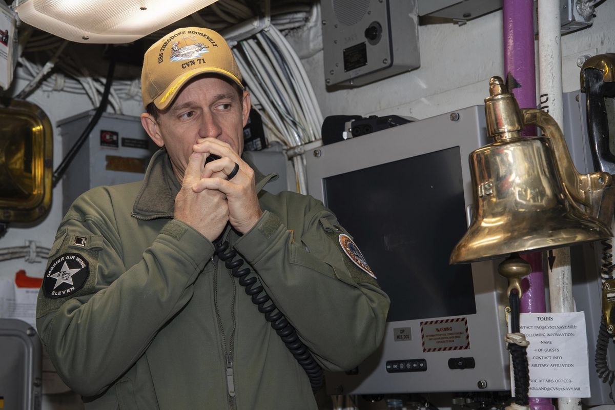 In this image provided by the U.S. Navy, Capt. Brett Crozier, then-commanding officer of the aircraft carrier USS Theodore Roosevelt (CVN 71), addresses the crew on Jan. 17, 2020, in San Diego, Calif. In a stunning reversal, the Navy has upheld the firing of Crozier, the aircraft carrier captain who urged faster action to protect his crew from a coronavirus outbreak, according to a U.S. official.  (Seaman Alexander Williams)