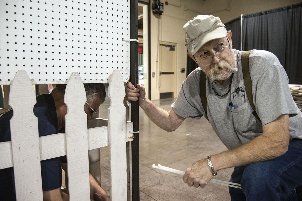 Jim Evans, right, and Earl Strickler, of LCD Exposition Services, add fencing to the base of display boards to be used to hang the fine arts gallery during the fair. DAN PELLE danp@spokesman.com (Dan Pelle / The Spokesman-Review)