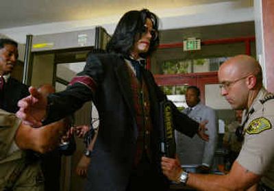 
Michael Jackson goes through security Thursday at Santa Barbara County Courthouse in Santa Maria, Calif.
 (Associated Press / The Spokesman-Review)