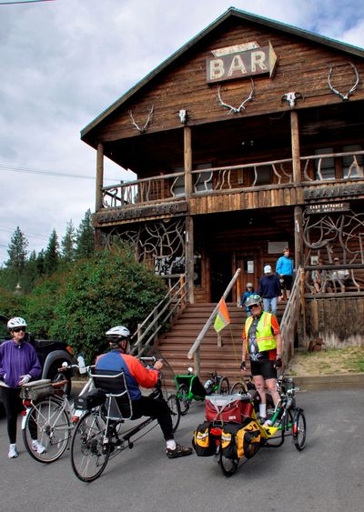 Cyclists riding the Trail of the Coeur d’Alenes stop for refreshments last month at the Enaville Resort, better known as the Snake Pit. After its owners died, the resort is open only for beer, soft drinks and milk shakes, Saturdays and Sundays, noon to 7 p.m. with no food service until a new owner assumes the property. (Rich Landers)