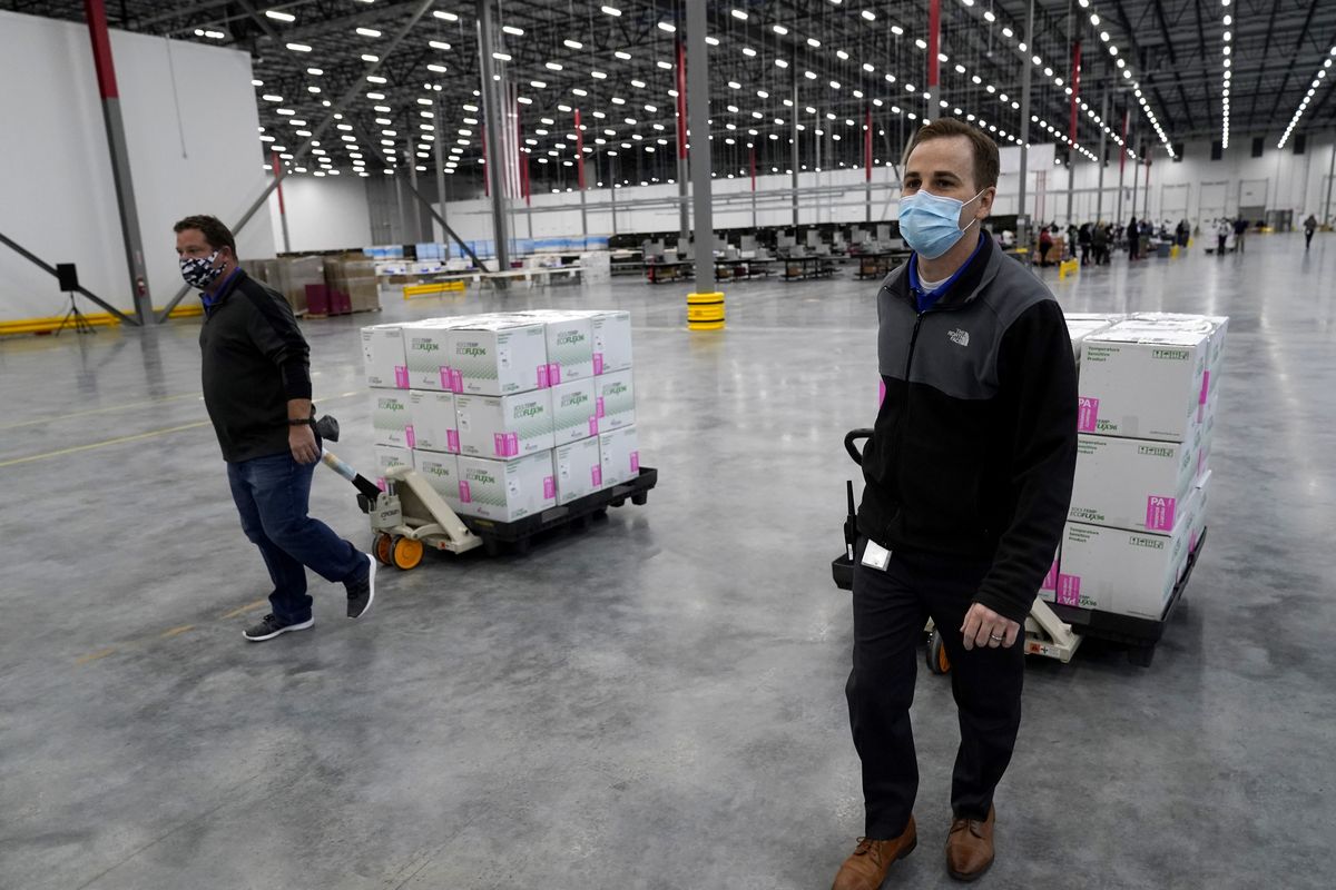 Boxes containing the Moderna COVID-19 vaccine are moved to the loading dock for shipping at the McKesson distribution center in Olive Branch, Miss., Sunday, Dec. 20, 2020.  (Paul Sancya)