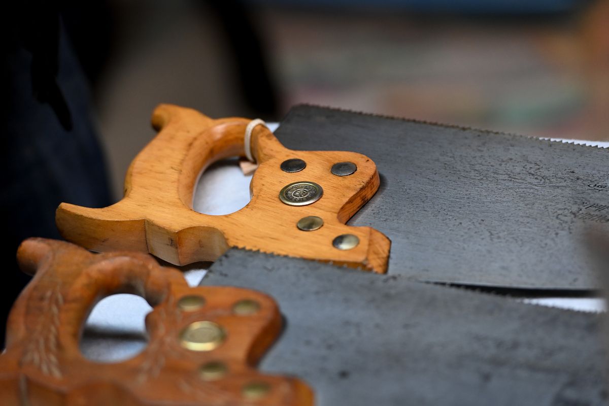 Dan Roos shows some of the hand saws in his collection on Thursday, Jan 13, 2022, at his home in Spokane Valley, Wash.  (Tyler Tjomsland/The Spokesman-Review)