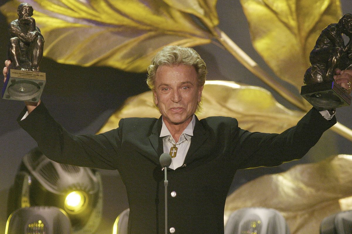 FILE - German illusionist Siegfried Fischbacher of the duo " Siegfried & Roy" holds their trophies after receiving the World Entertainment Award at the World Award 2003 ceremony in Hamburg, northern Germany, on Oct.22, 2003. German news agency dpa is reporting that Fischbacher, the surviving member of duo Siegfried & Roy has died in Las Vegas at age 81. The news agency said Thursday that Fischbacher’s sister, a nun who lives in Munich, confirmed his death of cancer. (Fabian Bimmer)