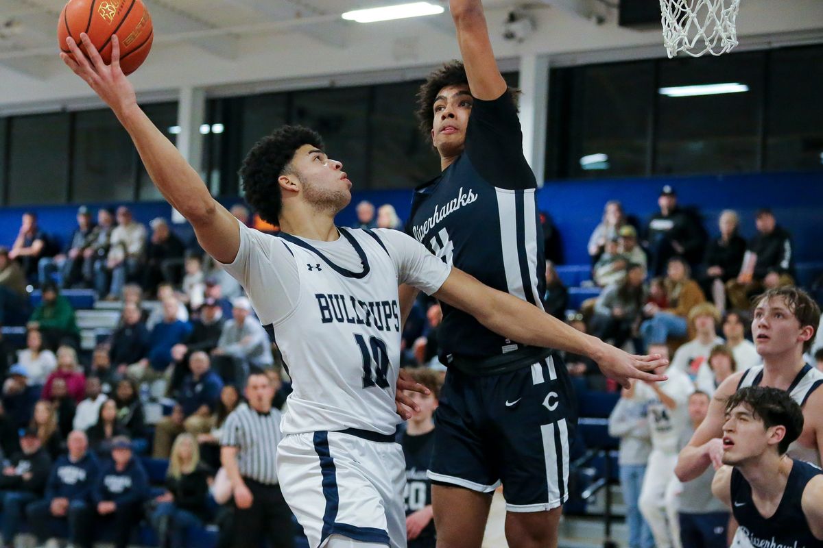 Gonzaga Prep forward Jamil Miller scores over Chiawana’s Donovin Young in the Bullpups’ 59-53 win Saturday at G-Prep.  (Cheryl Nichols/For The Spokesman-Review)