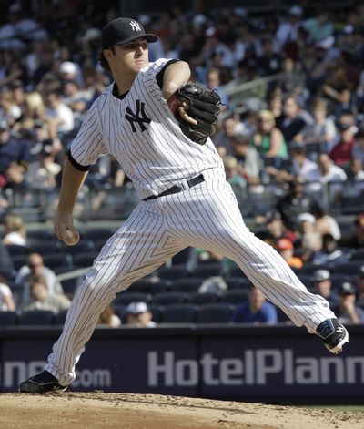 New York Yankees pitcher Phil Hughes throws in the third inning of a baseball game against the visiting Seattle Mariners on Saturday. The Yankees won the game 6-2. (Associated Press)