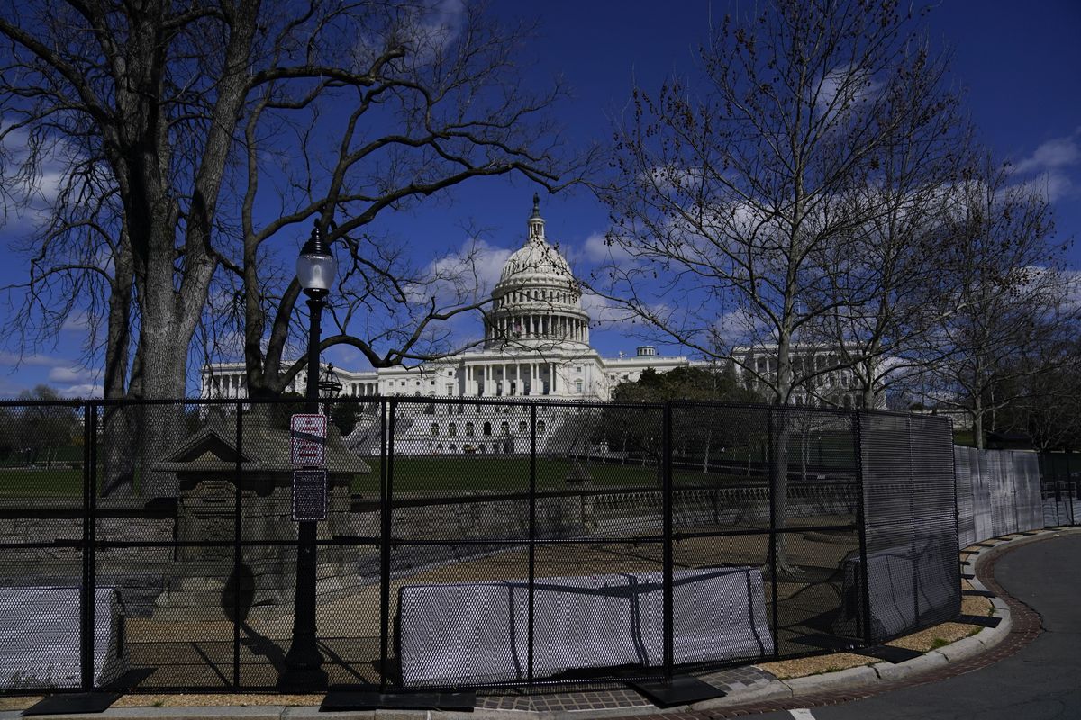 The U.S. Capitol is seen behind security fencing after a car that crashed into a barrier on Capitol Hill in Washington, Friday, April 2, 2021.  (Carolyn Kaster)