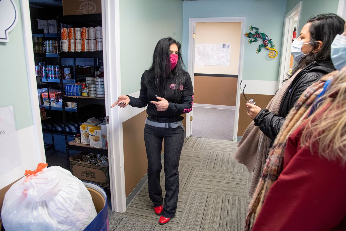 Julie Garcia, center, founder of of Jewels Helping Hands, pauses by the food pantry room while giving a tour of the new offices of Jewels Helping Hands at 1819 E. Springfield in east Spokane, shown Wednesday, Feb. 2, 2022. The former office building will operate as a drop-in center for people experiencing homelessness and offers a day-use room with snacks, clothing rooms, a computer lab and a place to meet with social service providers. (Jesse Tinsley/The Spokesman-Review)