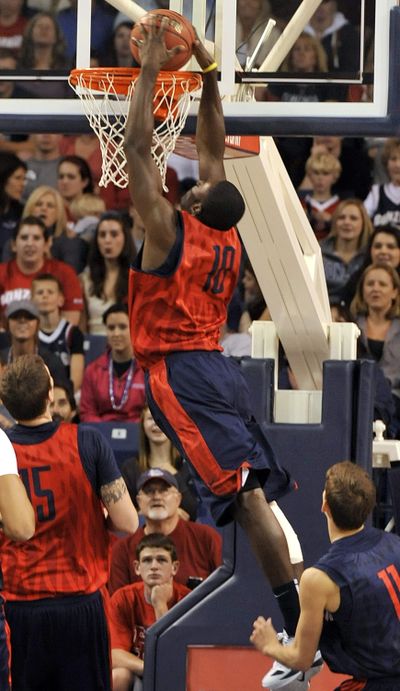 Junior college transfer Guy Landry Edi slams a lob pass for Gonzaga’s Red team during Saturday’s scrimmage. (Dan Pelle)