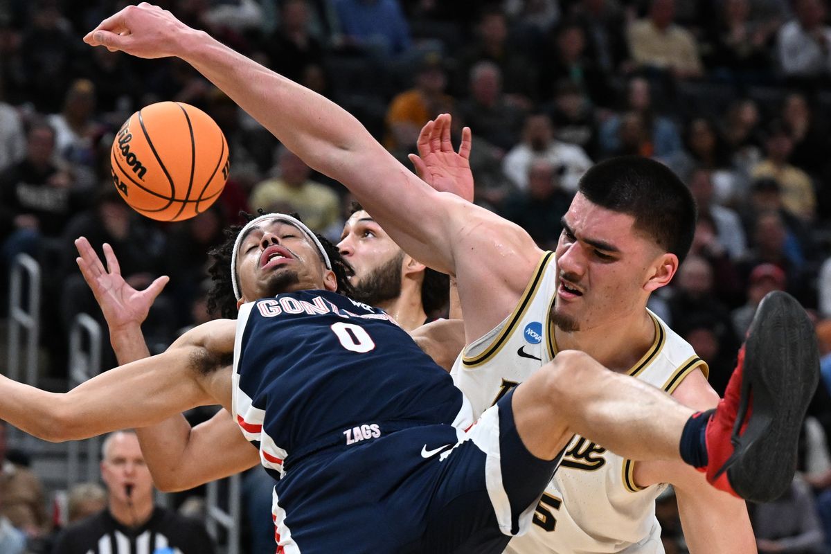 Gonzaga Bulldogs guard Ryan Nembhard (0) is called for a foul as he leaps for the ball against Purdue Boilermakers center Zach Edey (15) during the first half of an NCAA Tournament Sweet 16 basketball game on Friday, Mar 29, 2024, at Little Caesars Arena in Detroit, Mich.  (Tyler Tjomsland/The Spokesman-Review)