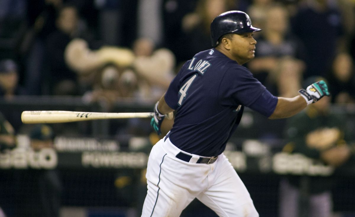 M’s Jose Lopez hits the winning RBI single in the ninth inning.  (Associated Press / The Spokesman-Review)