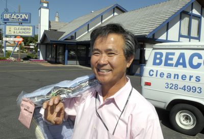 Hi Bum Kim, owner of Beacon Services Inc., stands in front of his store on Northwest Boulevard Wednesday.  (CHRISTOPHER ANDERSON / The Spokesman-Review)