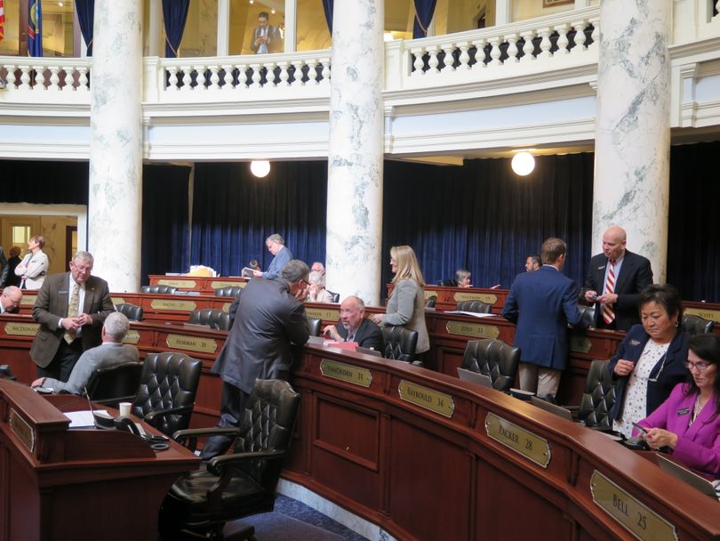 House members mill around in their chamber during an extended break, while GOP leaders met with Reps. Heather Scott, R-Blanchard, and Priscilla Giddings, R-White Bird, over their attempts to force full reading of bills in the House on Thursday. (Betsy Z. Russell)