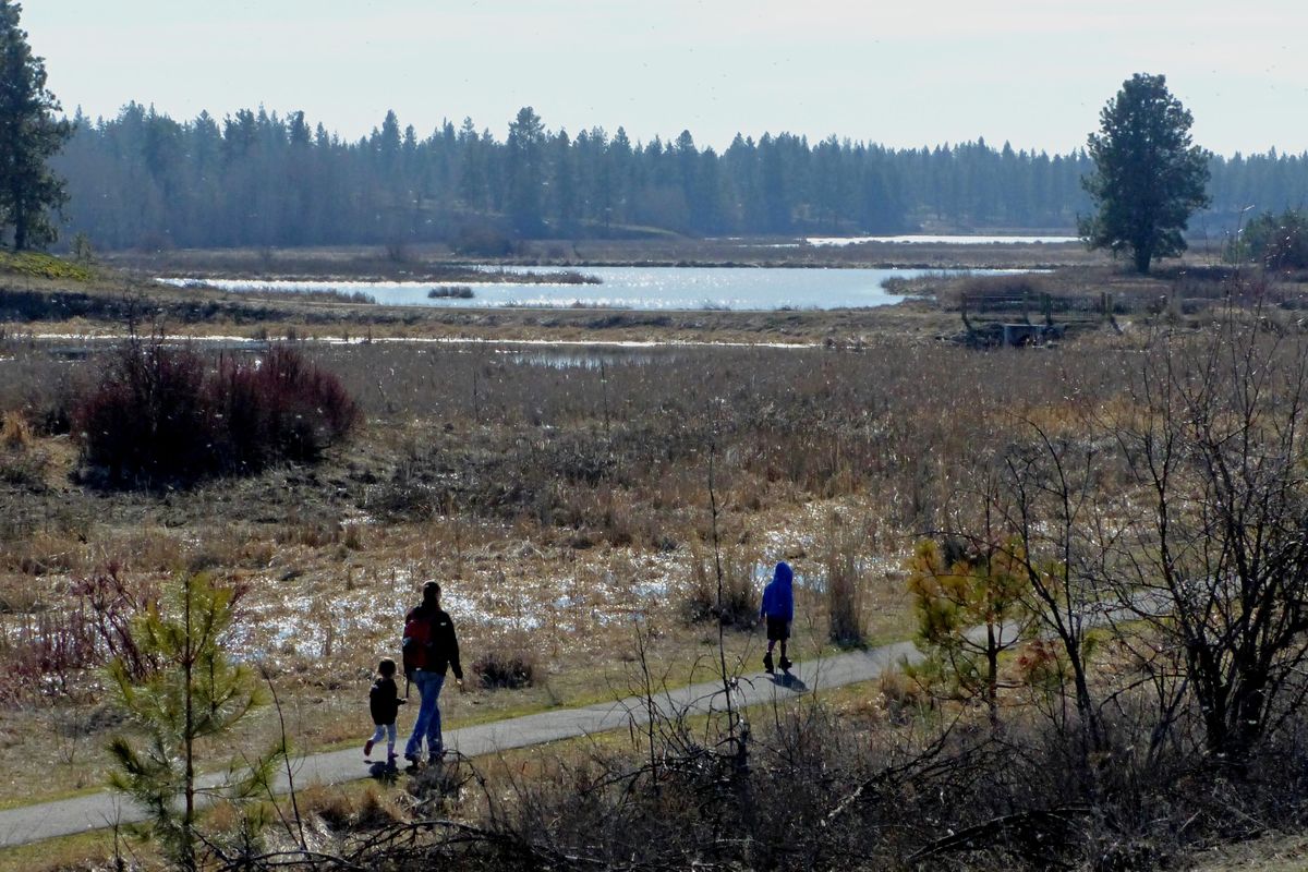 A family walks along a trail at Turnbull Wildlife Refuge Monday, Feb. 8, 2016. The Turnbull National Wildlife Refuge added about 1,500 acres of former ranch-land to its boundary in January. (Jesse Tinsley / The Spokesman-Review)