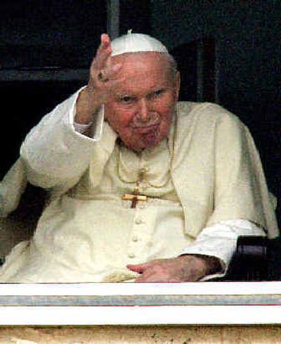 
Pope John Paul II waves at a window of his apartment on the 10th floor of Rome's Gemelli Polyclinic Hospital, where he was hospitalized after undergoing surgery to ease his breathing. 
 (Associated Press / The Spokesman-Review)