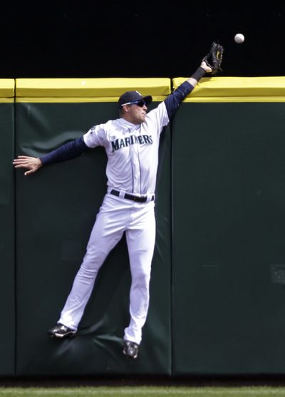 M’s Michael Saunders can’t snag homer by Ryan Raburn. (Associated Press)
