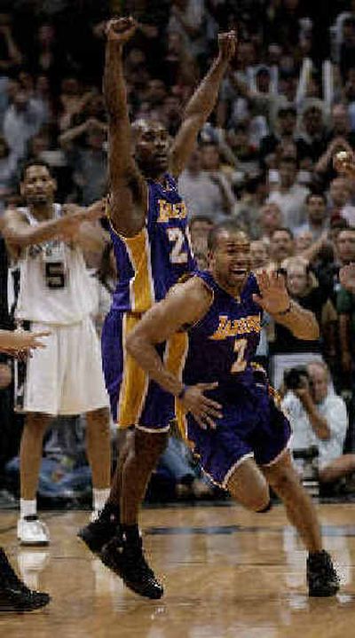 
Los Angeles Lakers guard  Derek Fisher, right, celebrates with teammate Gary Payton after the final buzzer of Game 5 in San Antonio. The Lakers can close out the series Saturday in L.A.  Los Angeles Lakers guard  Derek Fisher, right, celebrates with teammate Gary Payton after the final buzzer of Game 5 in San Antonio. The Lakers can close out the series Saturday in L.A.  
 (Associated PressAssociated Press / The Spokesman-Review)