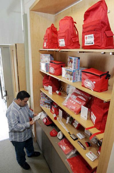 
A man looks over emergency and first aid kits at an American Red Cross store in San Francisco on Friday.
 (Associated Press / The Spokesman-Review)