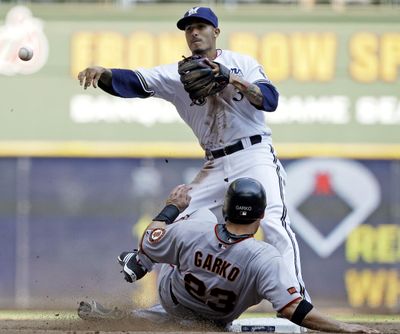 Brewers second baseman Felipe Lopez throws to first after forcing out Ryan Garko to complete a triple play. (Associated Press / The Spokesman-Review)