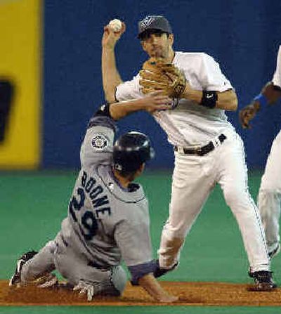 
Seattle's Bret Boone can't stop Toronto shortstop Chris Gomez from turning a double play in the third inning. 
 (Associated Press / The Spokesman-Review)