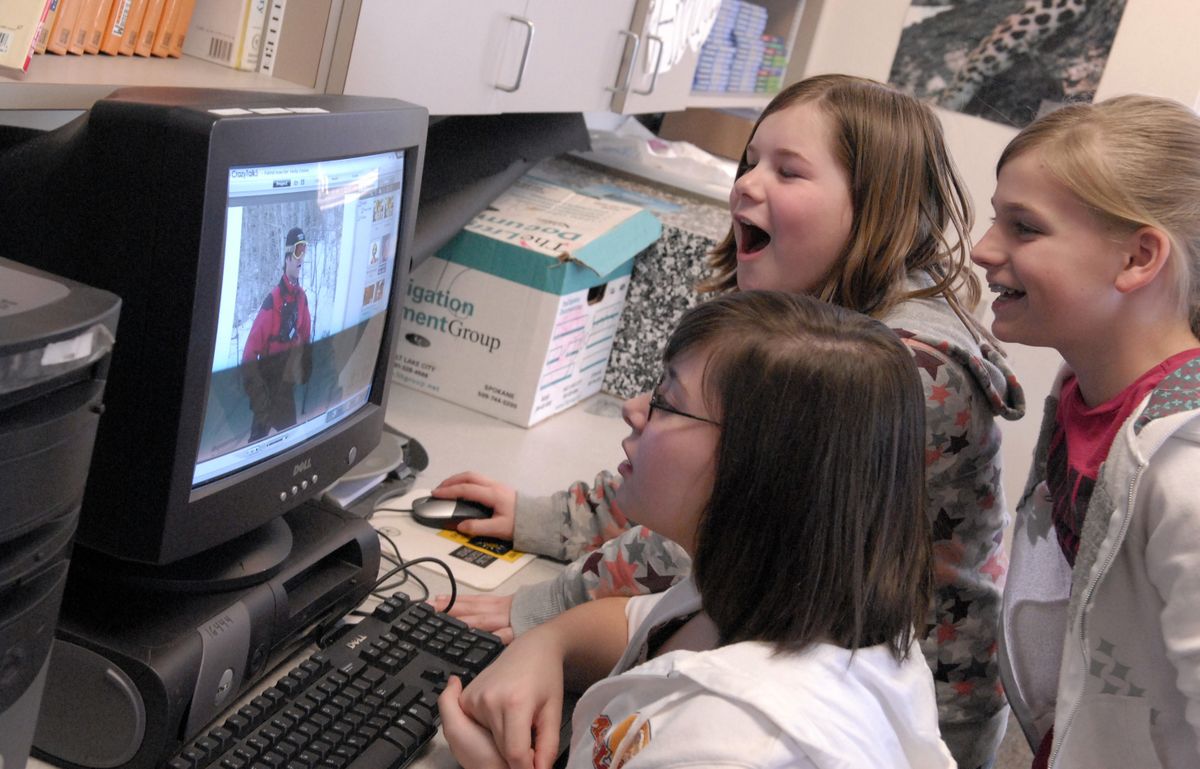 East Valley Middle School sixth-graders Yana Sarioglo, front, Olivia Maningas, middle and Rebecca Geibel  download pictures for a video during an  after-school computer technology class made available through a 21st Century Grant. “The enrichment activities have generated alot of enthusiasm,” commented principal Mark Purvive. (Photos by J. BART RAYNIAK / The Spokesman-Review)