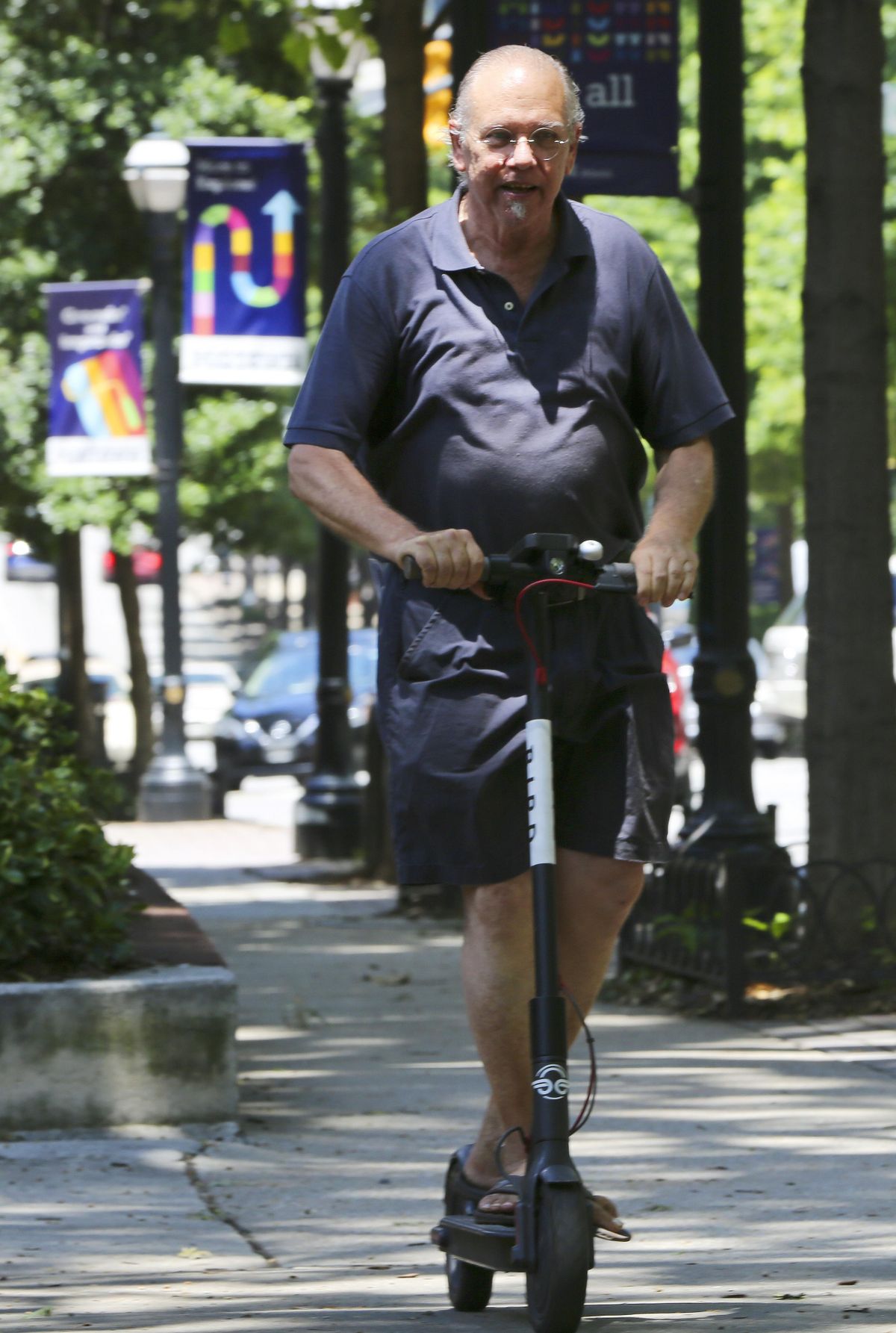 Robert Lowe, 71, rides an electric scooter in Atlanta this June. (Brinley Hineman / AP)