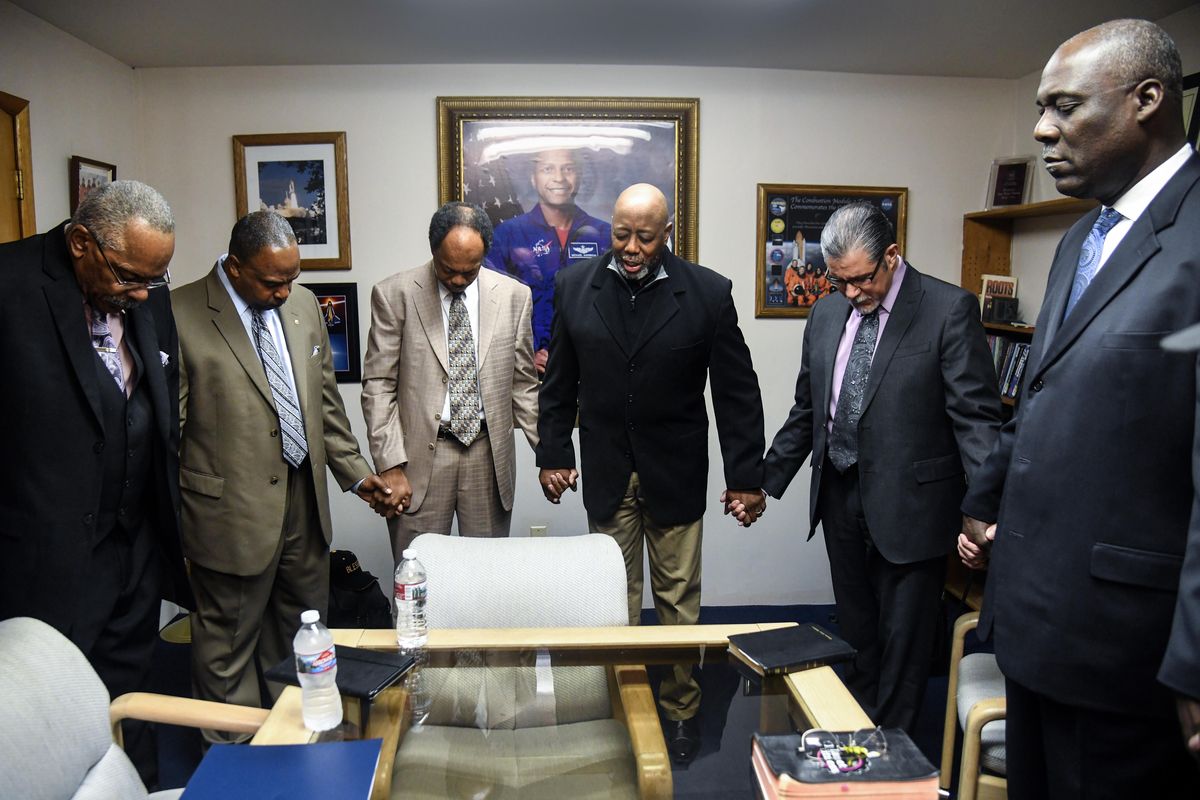 Revs. Donnie Stone and Walter Kendricks, of Morning Star Missionary Baptist Church, Rev. Otis Manning, of Word of Faith Christian Church, Rev. Amos Atkinson, of Calvary Baptist Church, Rev. Joe Veliz, of New Beginnings Ministry and Rev. Luc Jasmin, associate of Calvary Baptist Church, gather  for prayer March 29 at Morning Star Missionary Baptist Church. (Dan Pelle / The Spokesman-Review)
