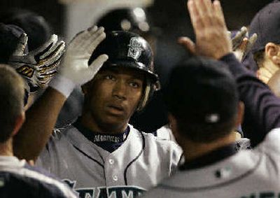 
Seattle's Jose Lopez is congratulated after hitting a two-run home run.
 (Associated Press / The Spokesman-Review)