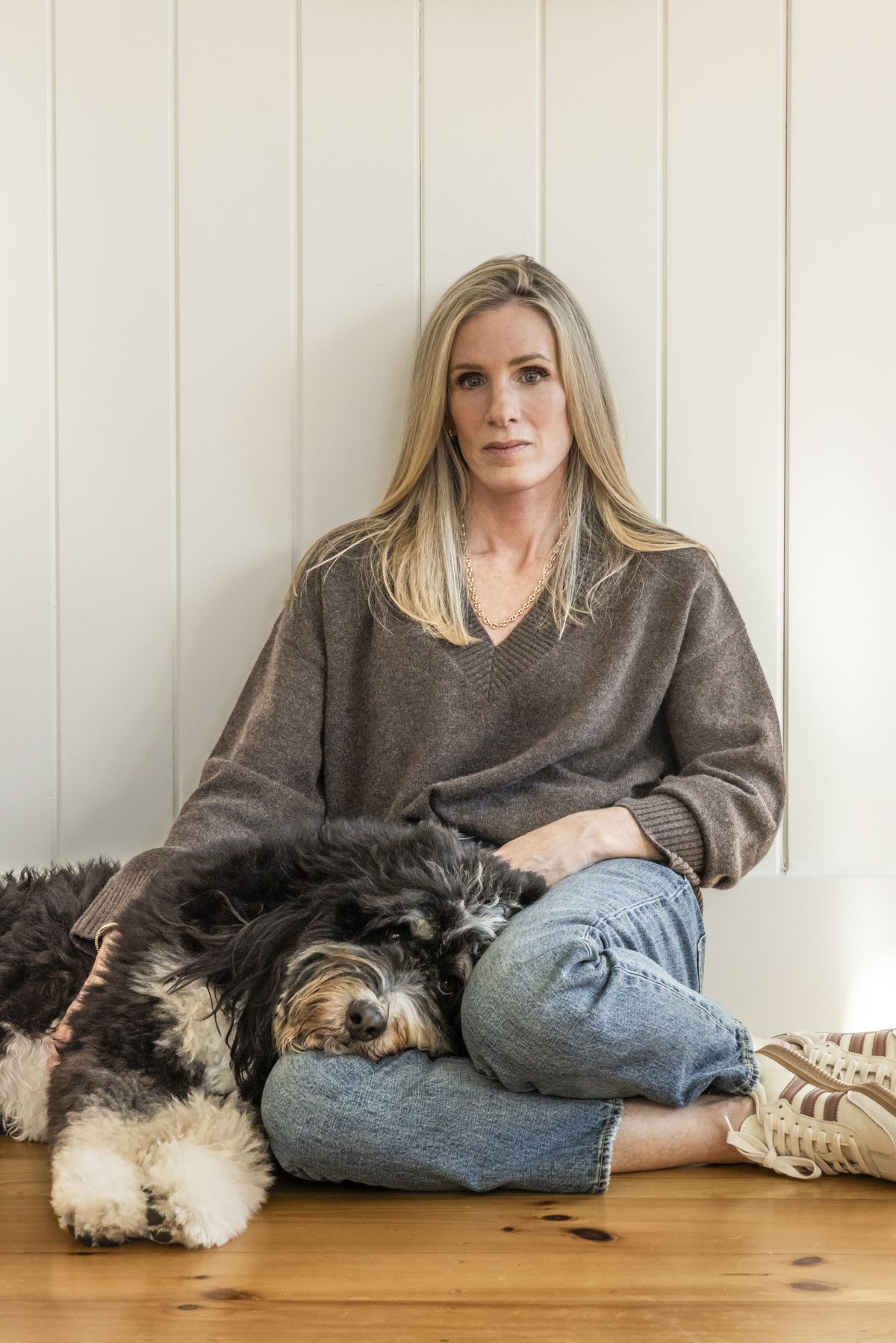 Kristin Cabot with her dog, Burt, at her home on Dec. 12 in New Hampshire. Cabot was caught on camera with her boss at a concert. The video went viral. Soon she was drowning in the vitriol of strangers.  (Greta Rybus/The New York Times)