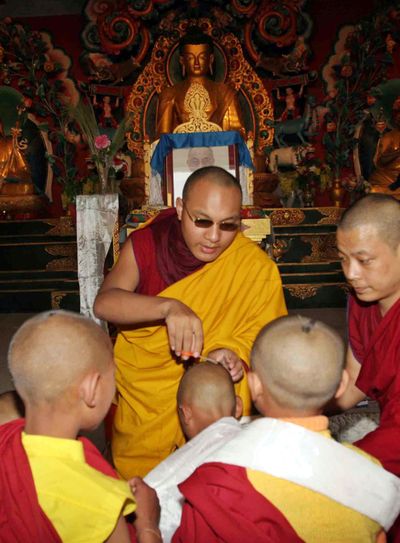 Ogyen Trinley Dorje, the 17th Karmapa and the third highest monk in Tibetan Buddhist hierarchy, blesses new monks after an initiation and empowerment session at Bodh Gaya, central India,  in 2006. The Karmapa is on a week-long pilgrimage of different holy Buddhist sites in central India.  (Associated Press / The Spokesman-Review)