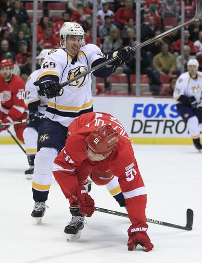 Nashville Predators defenseman Roman Josi checks Detroit Red Wings center Valtteri Filppula in Friday night’s NHL game. (Associated Press)