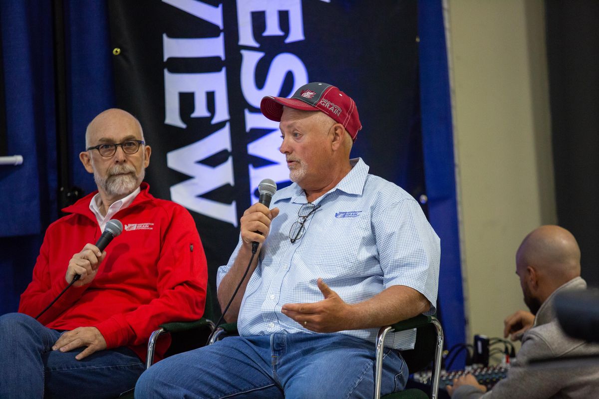 Scott Yates and Mike Cartensen of the Washington Grain Commission field questions from a talk called “Wheat Around the World” at the Spokane County Fair and Expo grounds on Sept. 12, 2018. Spokesman-Review Metro Editor John Stucke hosted the discussion. (Libby Kamrowski / The Spokesman-Review)