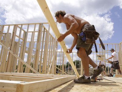Construction worker Akram Humaideh begins work on a new home in Springfield, Ill. A private-sector forecast of U.S. economic activity rose more than expected in June, thanks in part to new home plans. (Associated Press / The Spokesman-Review)