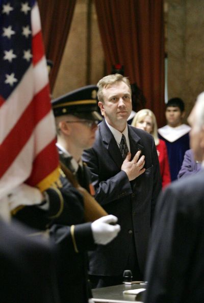 Rep. Doug Ericksen, R-Bellingham, stands at attention as the Military Color Guard passes with the flags during the opening ceremony of the 2006 legislative session in Olympia, Wash. Monday, Jan. 9, 2006. (JOHN FROSCHAUER / Associated Press)