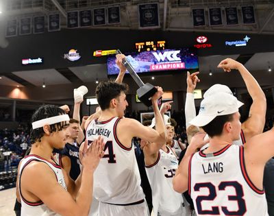 Gonzaga Bulldogs center Chet Holmgren (34) hoists the WCC trophy after the Bulldogs defeated the Santa Clara Broncos Saturday in Spokane.  (Tyler Tjomsland / The Spokesman-Review)