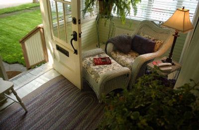 
The enclosed front porch, of this Coeur d'Alene home is decorated with sale items.
 (The Spokesman-Review)